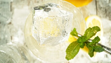 Closeup of ice cube inside glass of summer drink.