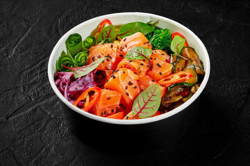 Salmon poke bowl with fresh vegetables and seaweed