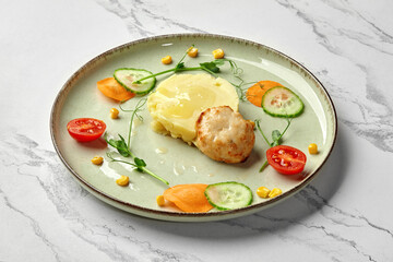Healthy baked chicken patty with mashed potatoes and vegetables