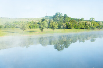 Fototapeta premium Beautiful summer landscape with green trees, green meadows on the bank of the river in Republic of Moldova.
