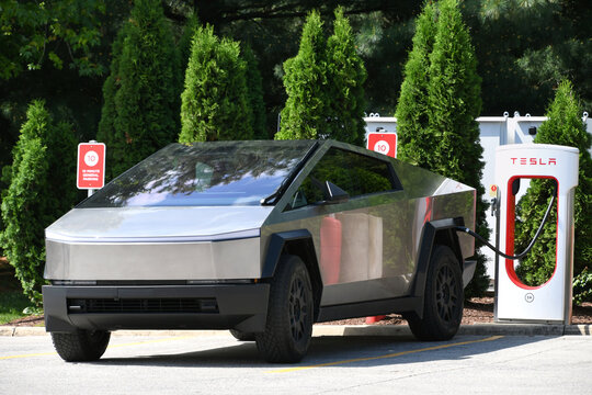 A Tesla Cybertruck EV electric vehicle plugged in and charging. 