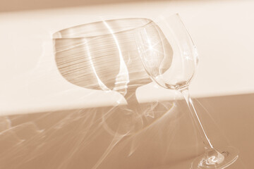 Sunbeams falls on glass for wine, top view glass sparkles in sunlight, still life with shiny...
