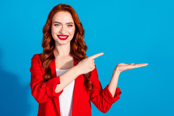 Obraz premium Photo of stunning lovely girl wear red stylish clothes demonstrate offer empty space isolated on blue color background