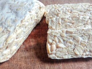 Tempeh or tempeh on the wooden plate. Traditional food from Indonesia. Made from fermented soybean.