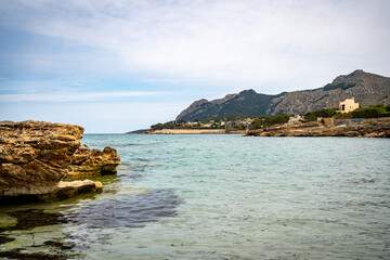 Rocky beach in the Victoria town in Mallorca Spain on a cloudy summer day