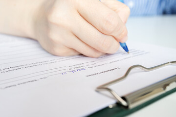 Construction contract, hand fills out a document, housing project planning session, apartment purchase agreement signing