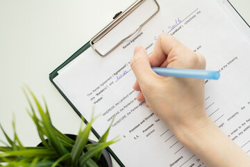 Rental agreement, hand fills out a document, property management, residential lease