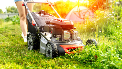 Lawn mower on a green flat lawn on a sunny day