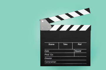 Cinema clapper board on a green background, copy space, show, assistance, script.