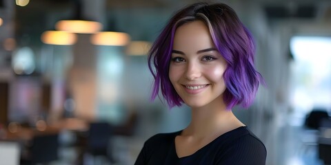 Portrait of young woman with short ombre purple hair smiling in office. Concept Office environment,...