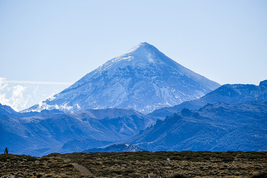 Lanin volcano surrounded by clouds, clear summit in sight and ice glaciers, between Argentina and Chile, Lanin National Park