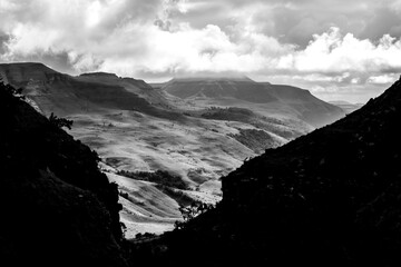Dramatic black and white view of the Drakensberg mountains of South Africa framed the the black...