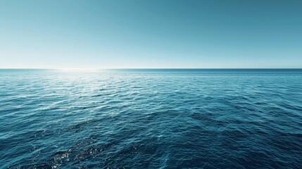 Obraz premium A panoramic view of a big, blue ocean stretching as far as the eye can see, under a clear sky