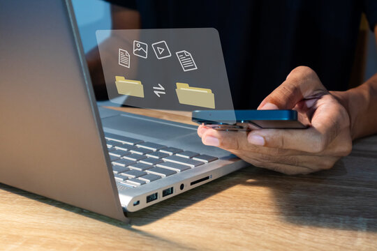 File transfer between mobile phone and laptop. Copy file and media or exchange data on virtual screen. - Powered by Adobe