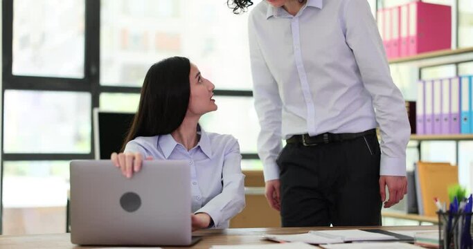 Interested curious corporate spy looking at colleague laptop. Manager deceives and steals idea and partner