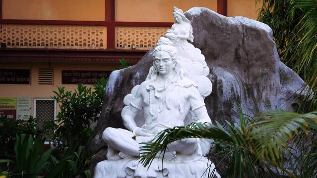 white statue of god shiva meditating