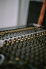 Fototapeta premium An audio mixer with its knobs and sliders meticulously adjusted, embodying precision and control in the art of sound engineering and music production