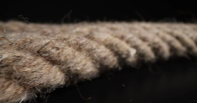 Closeup of marine rope on black background. Twisted braided rope