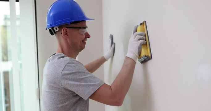 Grinding wall with sanding block master. Preparation before painting house renovation concept