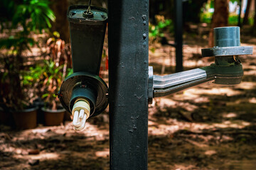 Broken bulb. Old dilapidated street lamp in garden. Broken and damaged light bulbs with lamp shade on pole in park. Broken and damaged white incandescent lamp. Outdoors Electrical hazards concept.
