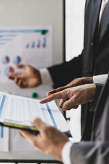 Business consulting meeting, strategy analysis and business planning. Businessmen discuss growth analysis on financial charts and investment graphs.