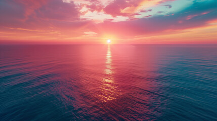 Obraz premium Aerial view of the ocean meeting the sky at sunset