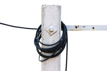 The black wire is long rolled on a cement pole isolated on white background.