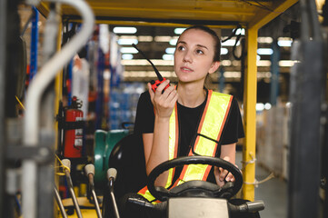 warehouse, radio, and forklift in shipping warehouse. Female transport worker in safety uniform...