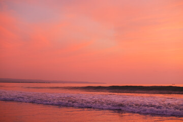 Beautiful peach sunset over the ocean. Beautiful view of pink sky