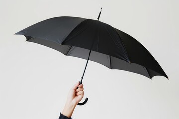 image of a hand holding a black umbrella on white background 