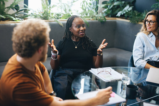 Black business woman talking to her colleagues during a team meeting in an office