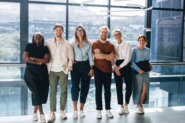 Group of professional business people smiling at the camera happily