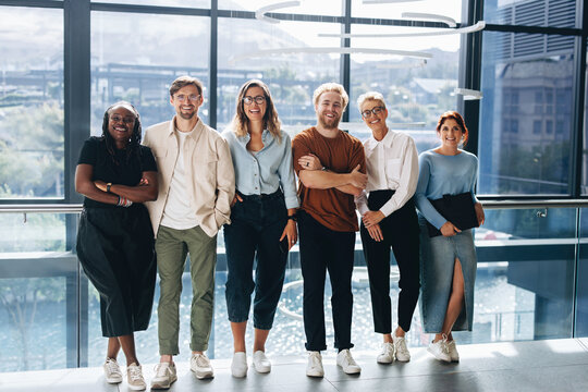 Group of professional business people smiling at the camera happily