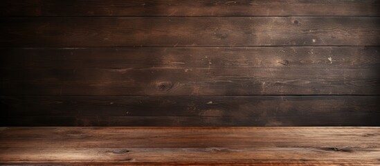 An abstract desk with a vintage grunge wallpaper of an old floor wooden pattern The dark grain panel board table has a wood plank texture that creates a timber plank surface on the wall providing cop