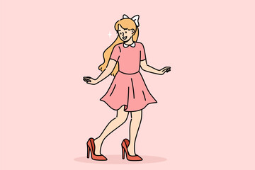 Little fashionista girl tries on mother shoes and smiles, imitating mom and wanting to grow up faster. Funny pre-teen fashionista smiling, imagining walking down catwalk at fashion party