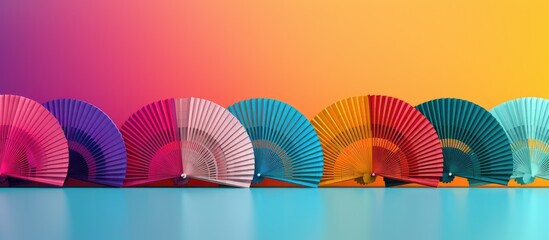 Various handheld fans against a colorful backdrop with copy space image