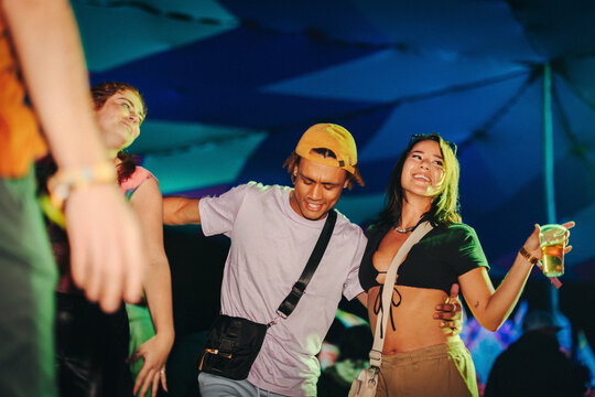 Group of friends dancing to the beats at a summer festival