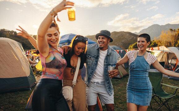 Happy friends groove and celebrate together at a a music festival