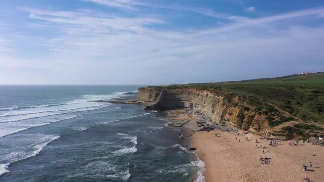 Ribeira D'Ilhas Beach, Cliffs and Atlantic Ocean Waves on Sunny Day. Portugal. Aerial View. Drone Moves Forward and Upwards