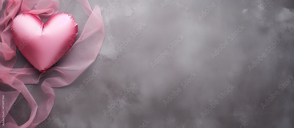 Poster valentine s day themed composition featuring a pink heart on a gray background viewed from above wit