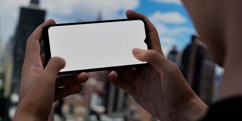 Smartphone with blank screen over cityscape, ideal for urban tech promotions