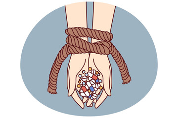 Hands of connected person with antibiotics and psychotropic drugs as metaphor for addiction to pills with narcotic effect. Uncontrolled use of antidepressants and amphetamine pills is addictive