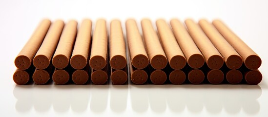 A neatly arranged biscuit wafer stick or roll with chocolate on a white background providing copy space for text or other elements