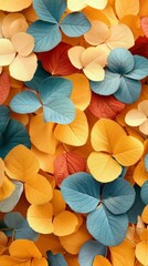This image showcases a close-up view of multicolored autumn leaves. The warm tones and textured details provide a seasonal backdrop suitable for various creative projects.