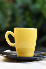 yellow porcelain cup on the breakfast table tea and coffee