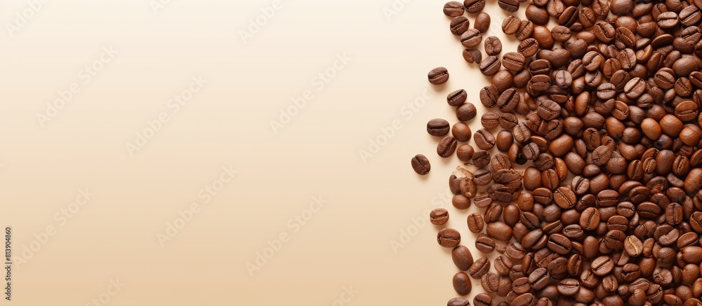 Poster top view of roasted coffee beans scattered on a beige background creating a copy space image