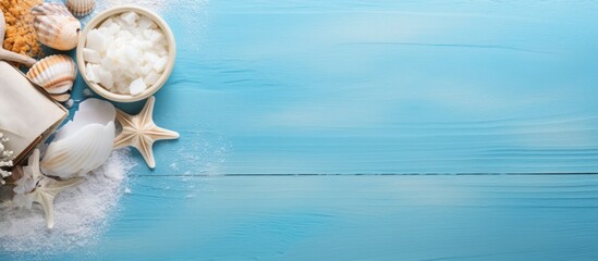 Plakat Top view copy space image of sea salt spa and aroma spa cosmetics accompanied by a towel and shells all set against a serene blue background