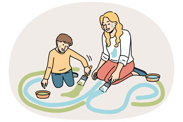 Smiling mother and son painting on ground together. Happy mom and child have fun drawing with paints on street. Motherhood concept. Vector illustration.