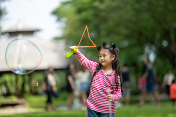 Young Girl Playing with Giant Bubble Wand
