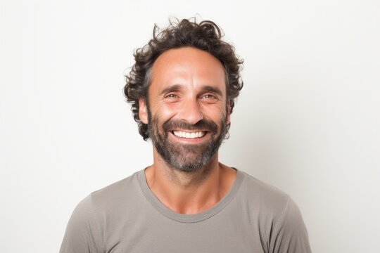 Portrait of a grinning man in his 40s smiling at the camera isolated in white background